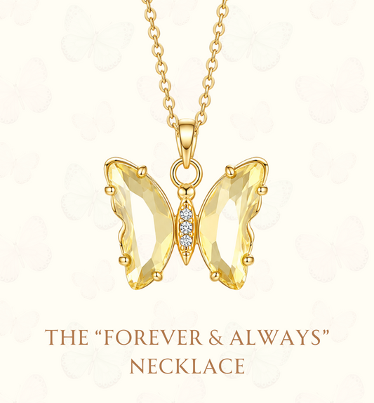 A gold butterfly pendant necklace with clear faceted gemstones on a white background, featuring the text 'THE "FOREVER & ALWAYS" NECKLACE' and the website 'www.hebejewel.
