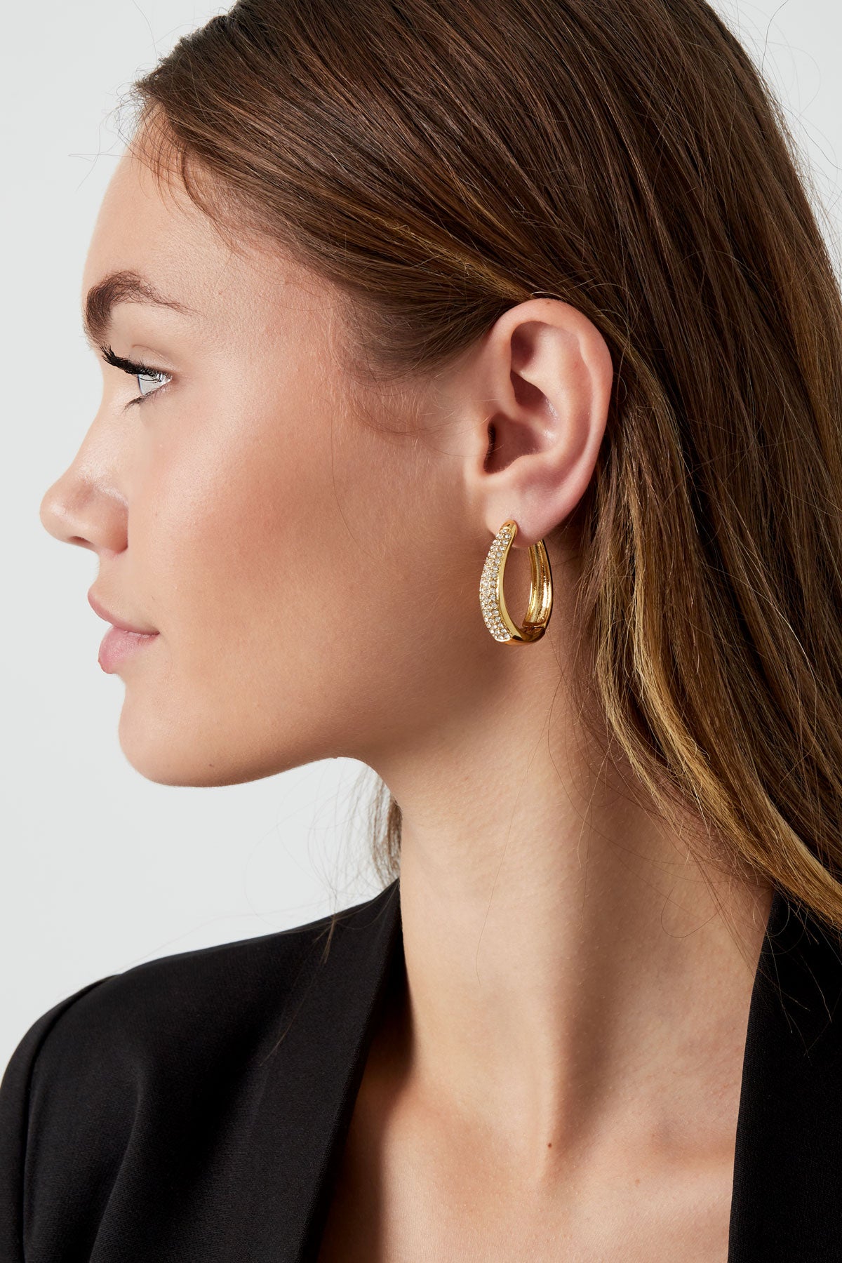 stylish woman wearing golden earrings with zirconn