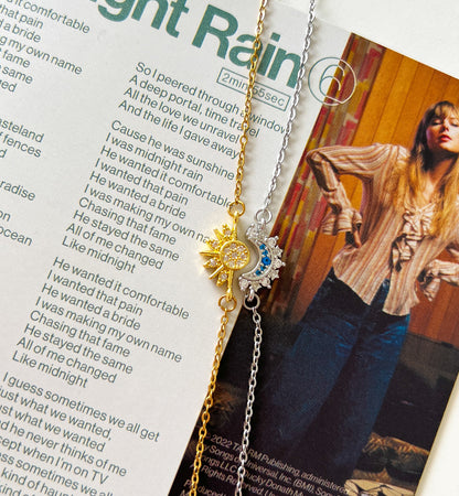 Necklace with sun and moon charms on a magazine page