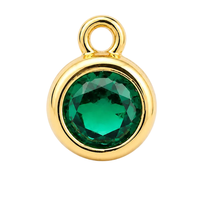 A round gold pendant charm featuring a faceted green gemstone in a bezel setting, complete with a top loop, shown on a clean white background.