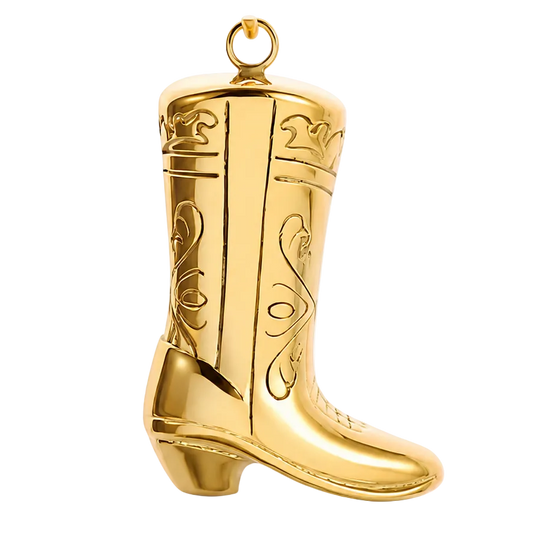 A shiny gold cowboy boot ornament or figurine with decorative engraved patterns and a hanging loop at the top, shown on a clean white background.