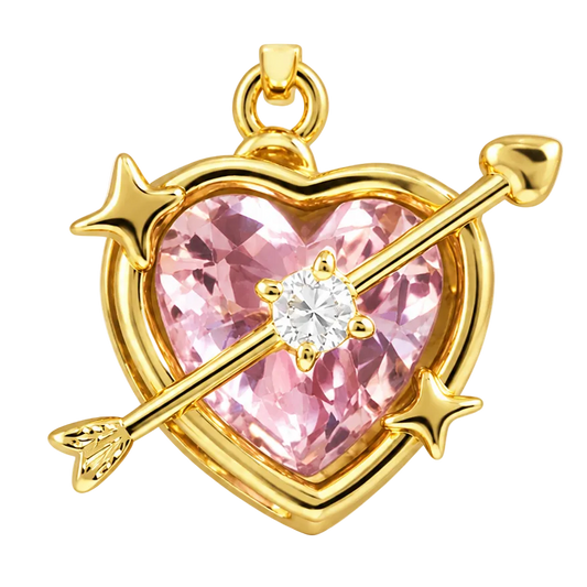 A gold heart-shaped pendant featuring a faceted pink gemstone in the center, crossed by a gold arrow with two small gold stars, on a plain white background.
