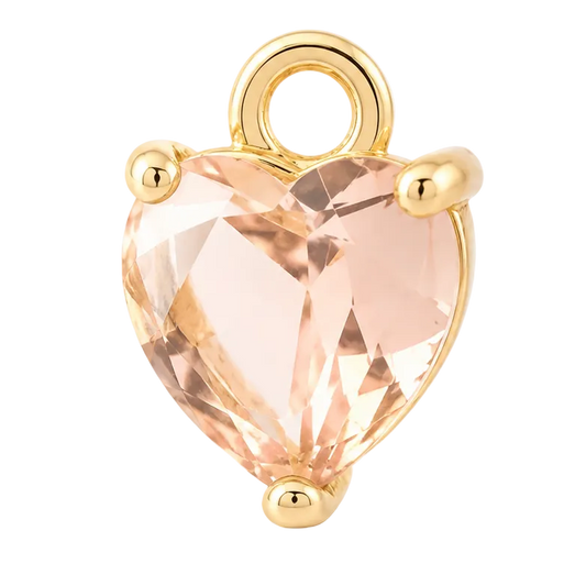 A heart-shaped faceted peach crystal pendant charm set in a gold-tone metal prong setting with a top loop, shown on a clean white background.