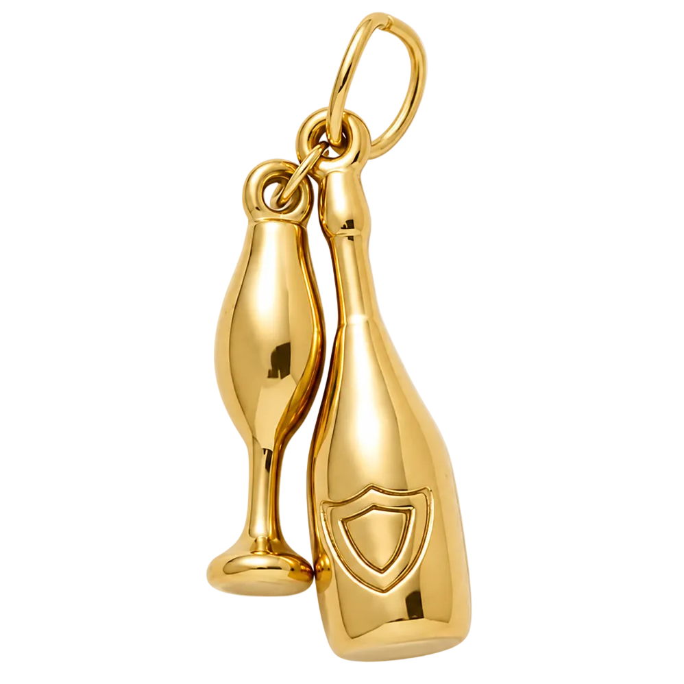 A polished gold charm featuring a champagne bottle and a champagne flute, attached to a gold loop at the top, shown against a light gray background.