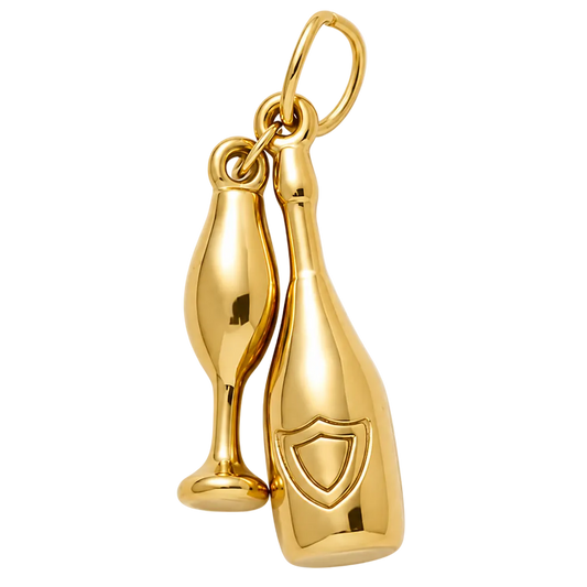 A polished gold charm featuring a champagne bottle and a champagne flute, attached to a gold loop at the top, shown against a light gray background.