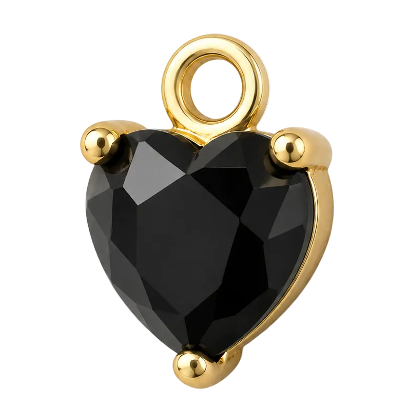 A heart-shaped faceted black gemstone charm in a gold prong setting with a top loop, shown on a clean white background.